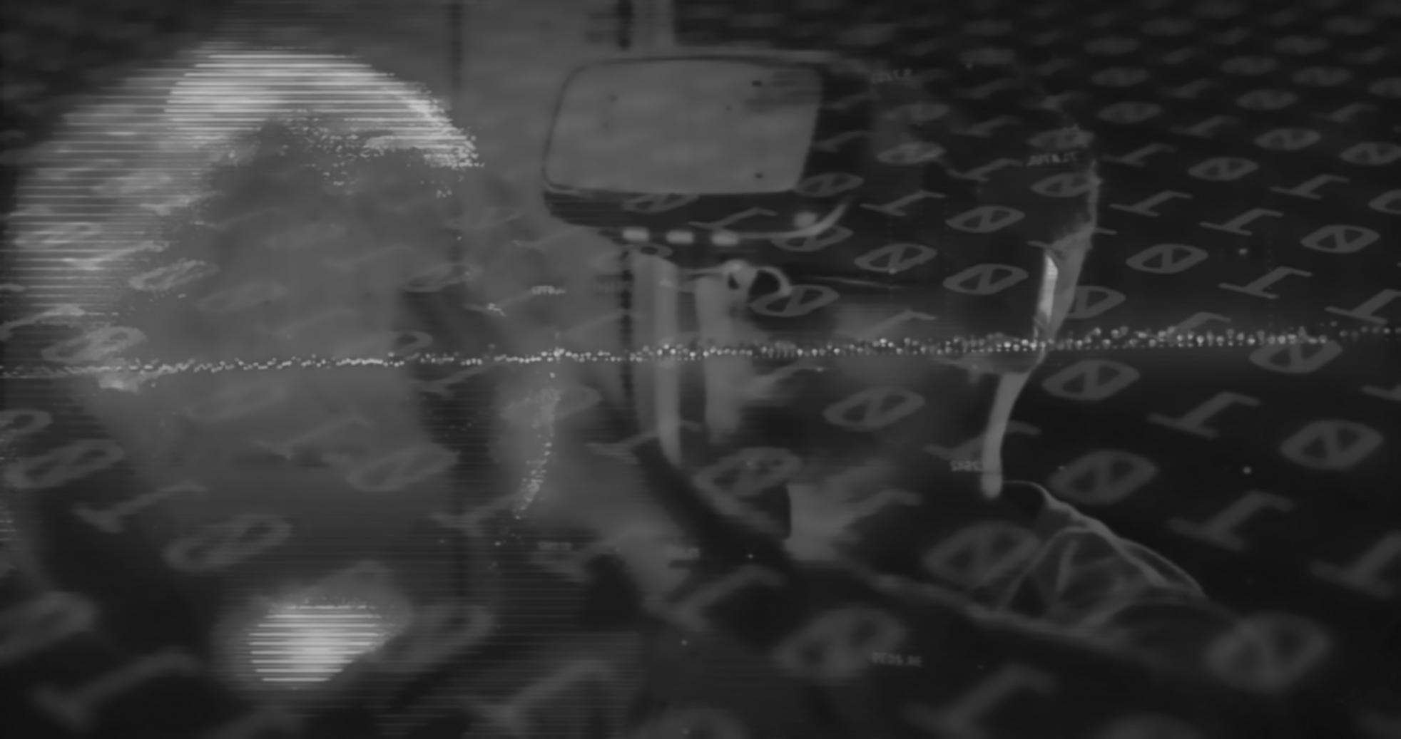 Instructor reviewing student project on large display monitor